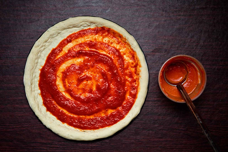 Pizza sauce on dough