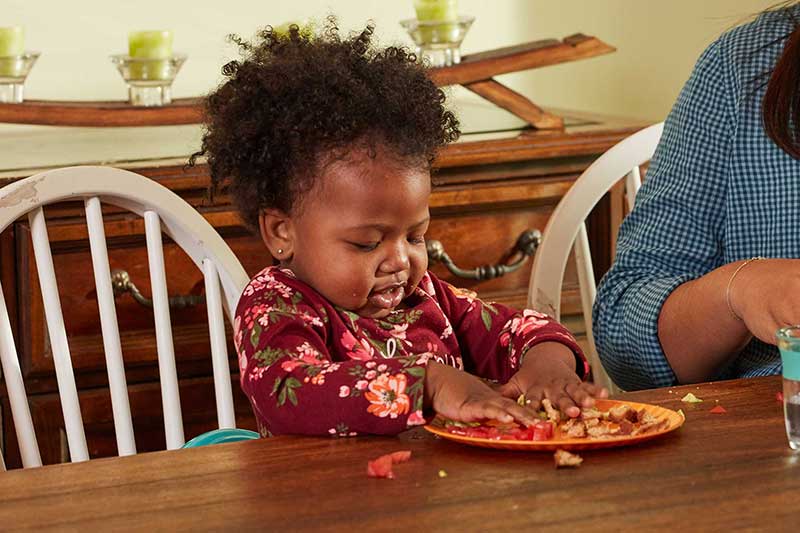 toddler playing with food