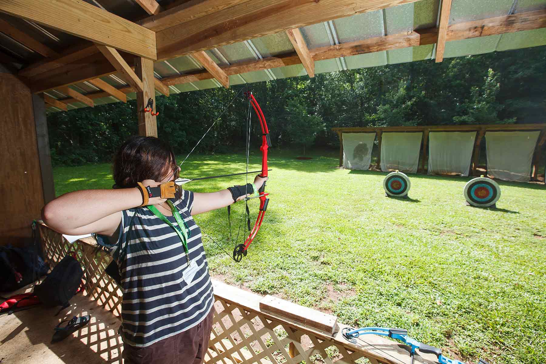 Girl and boy shooting bow and arrow