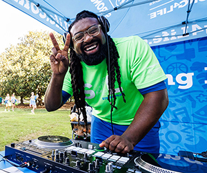 DJ 412 from the Challenge Team mixing beats at a community event