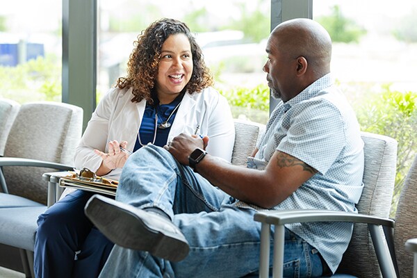 Doctor and parent talking about paperwork in the lobby at the office