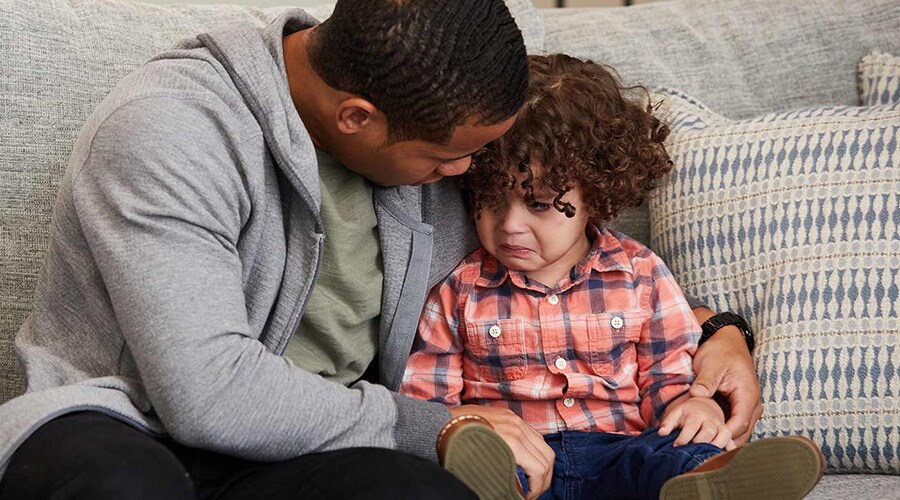 Dad helping upset toddler calm down