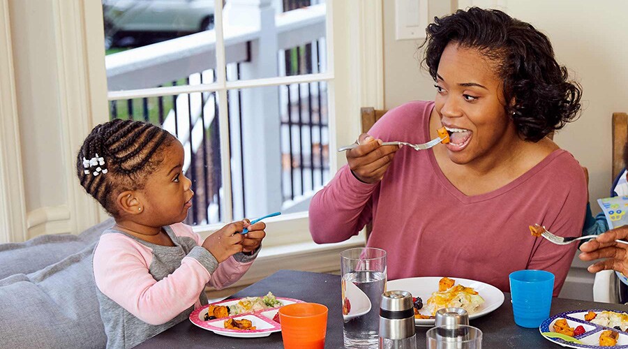 Mom and toddler eating a balanced meal together