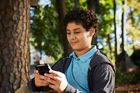 boy looking at cell phone
