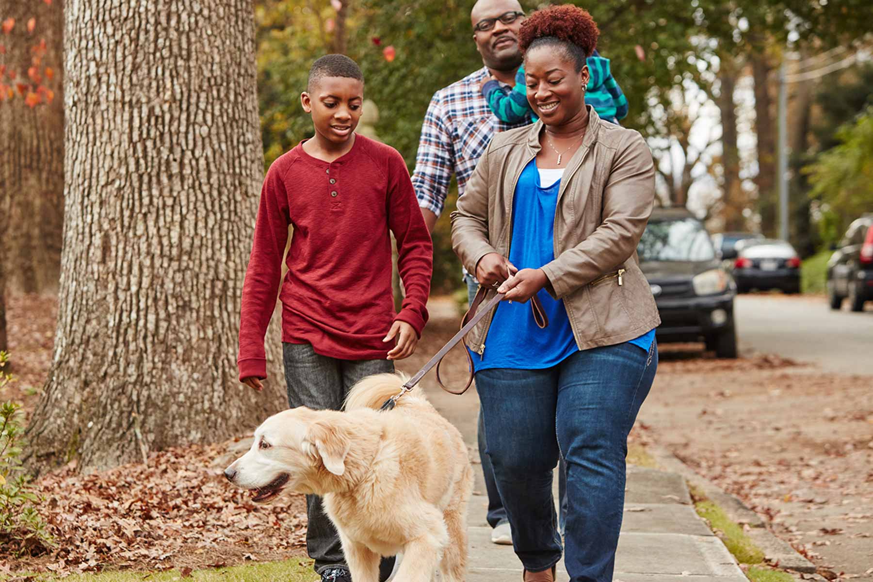 family taking walk with dog