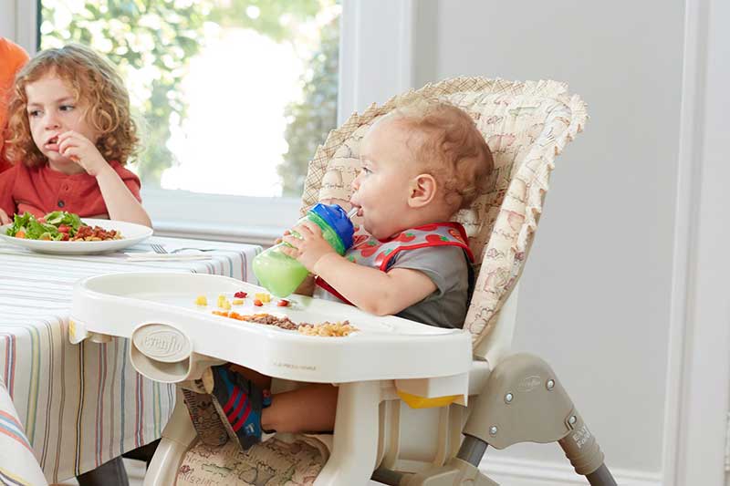 12 month old drinking milk from straw cup