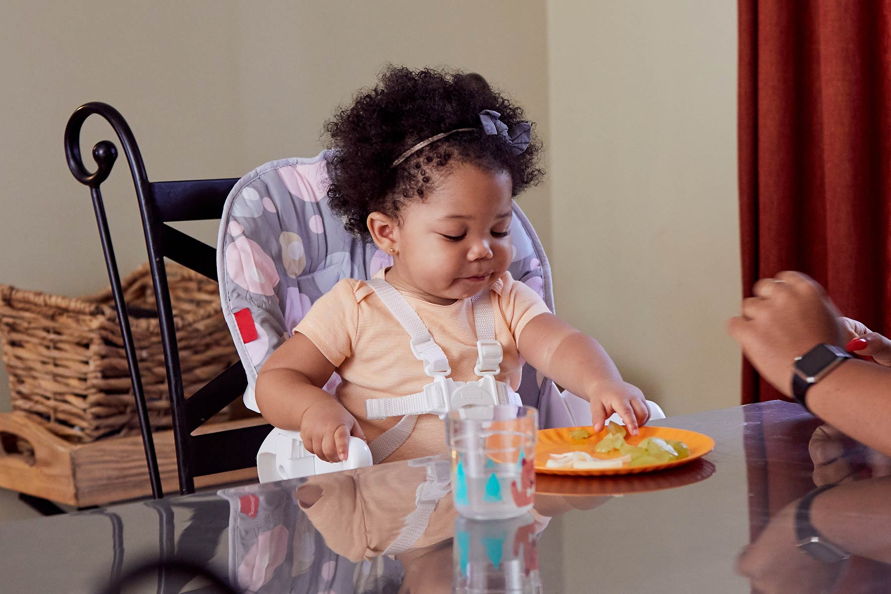 infant eating cut up grapes
