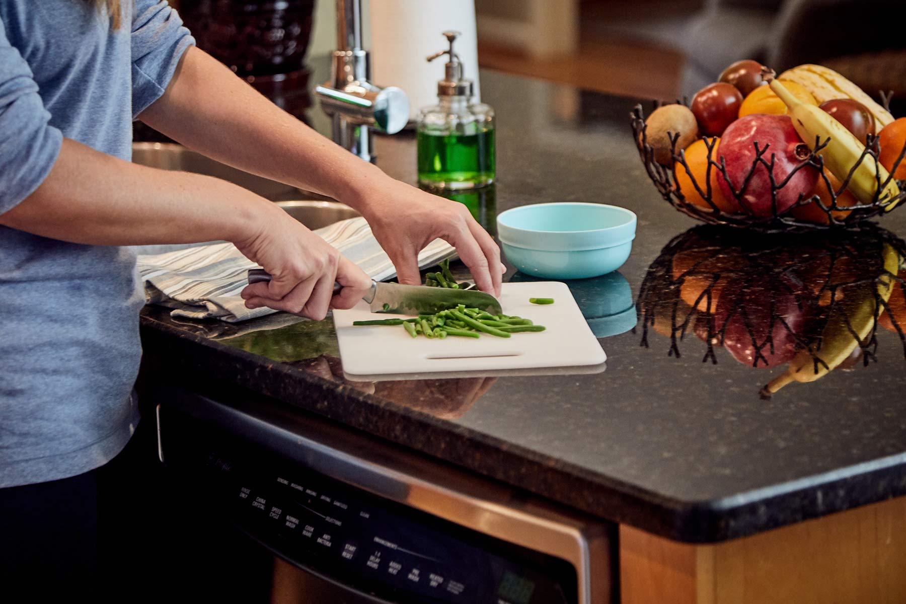mom chopping up food for baby into small pieces