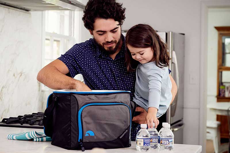 dad packing small cooler of water