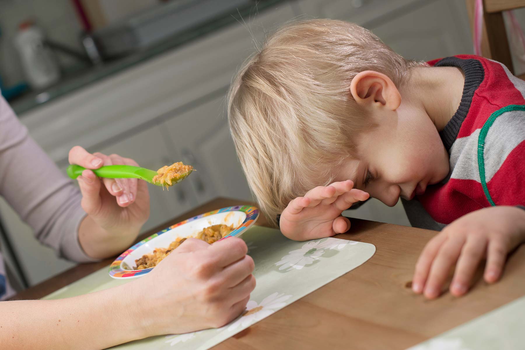 boy pouting at table