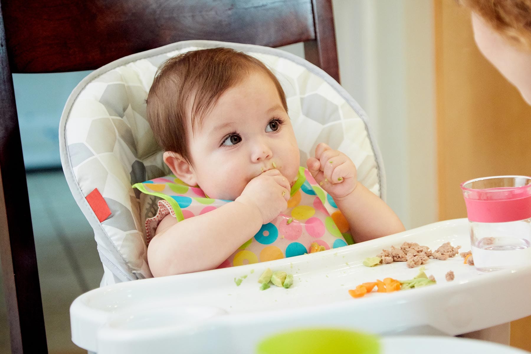 infant eating avocado and ground meat