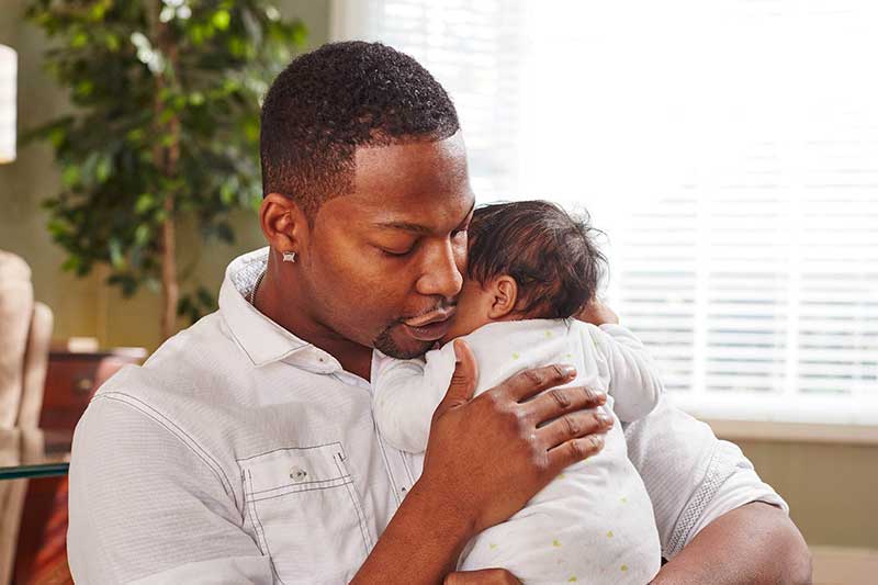 Dad consoling baby