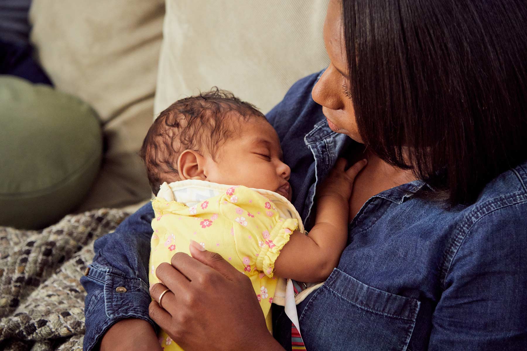 newborn sleeping in mom's arms