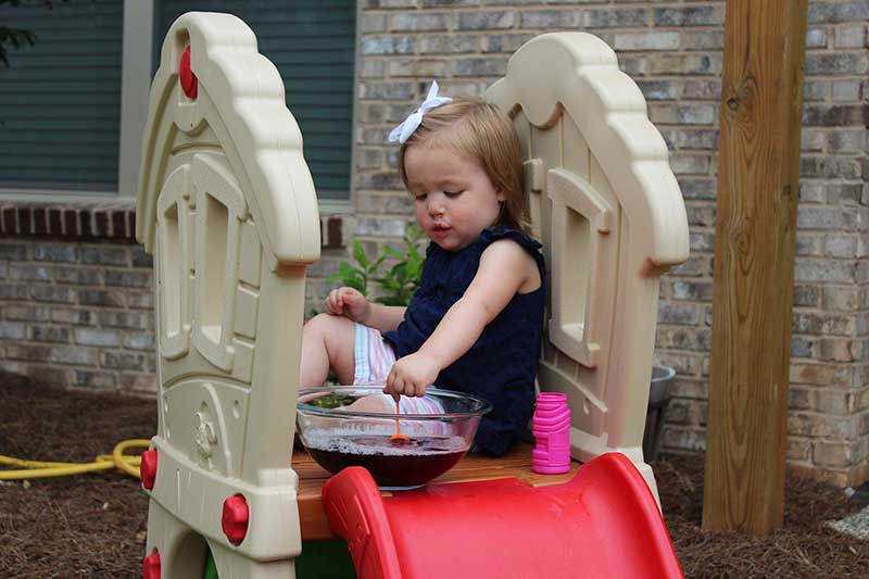 Toddler blows bubbles