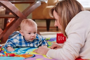Photo shows mom and baby doing tummy time at 4 months