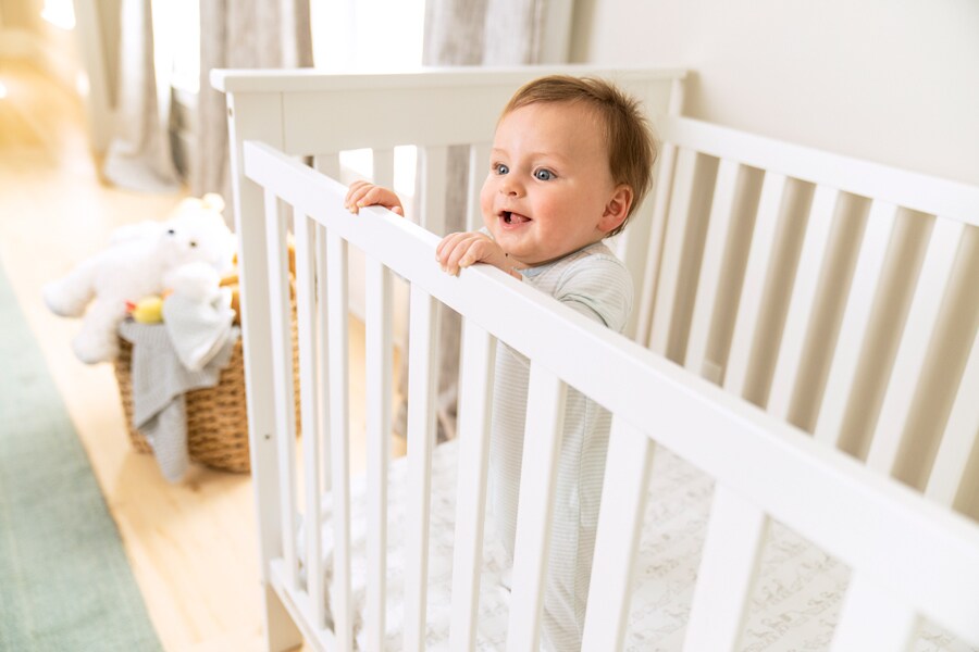 Infant pulls up to stand while in their crib