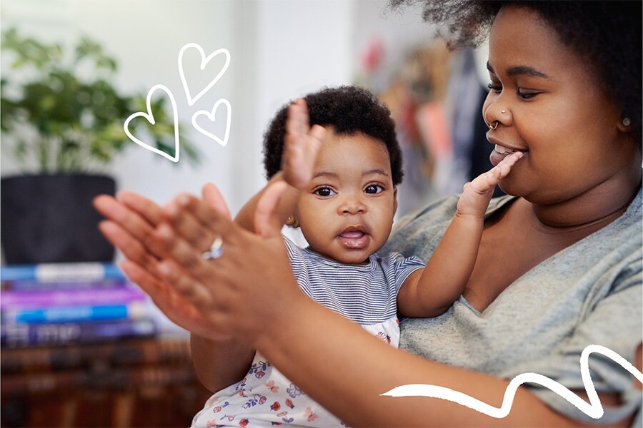 15-month-old practices clapping while mother role models how to do it.