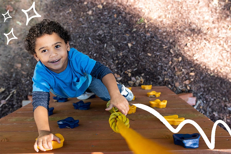 A 5-year-old child enjoys fun activities for kids, like climbing on playground equipment.
