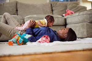 Mom shows the benefits of tummy time as she bonds with her baby
