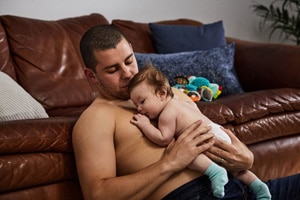 Dad does skin-to-skin contact with child for newborn tummy time