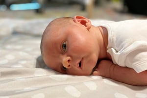Newborn baby safely showing when to start tummy time