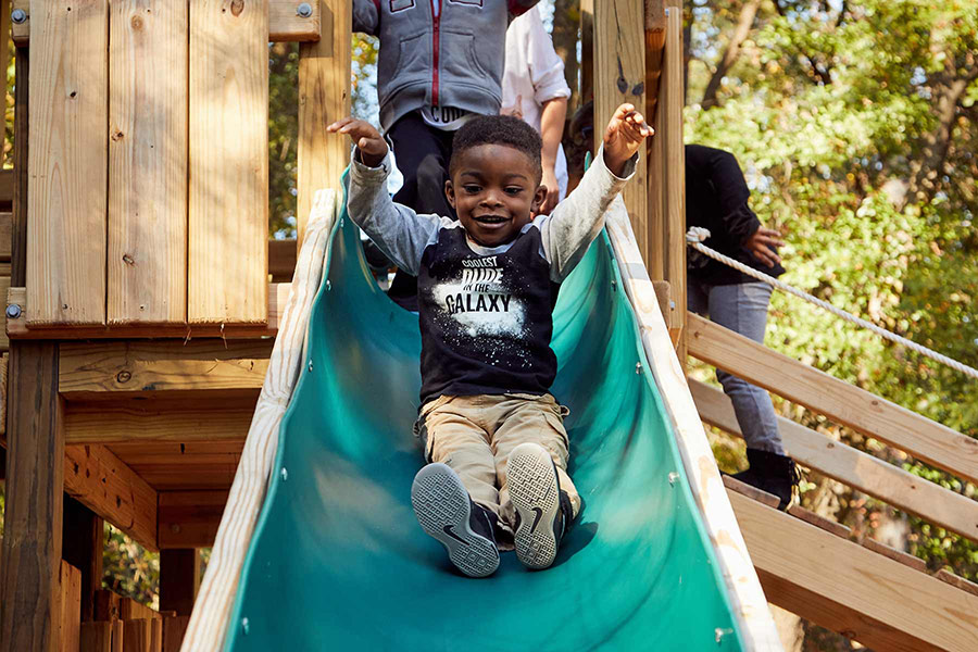 boy going down slide