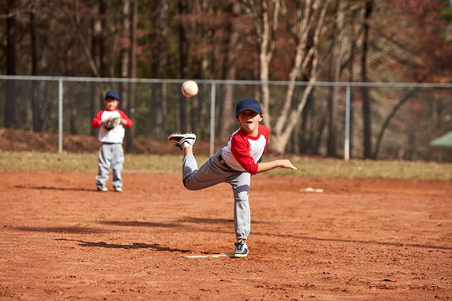 boy pitching baseball