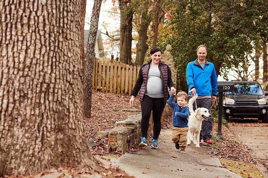 family taking a walk with their dog