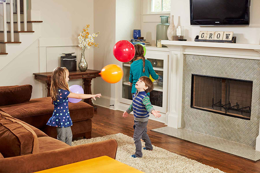kids playing with balloons in living room