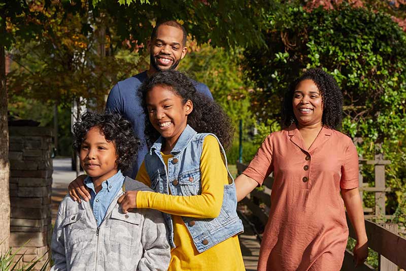 family walking on sidewalk