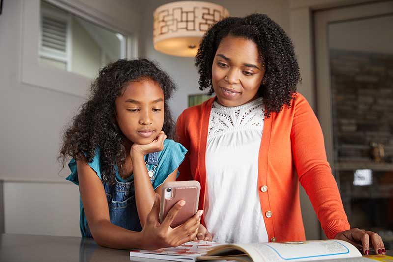 mom and daughter looking at social media