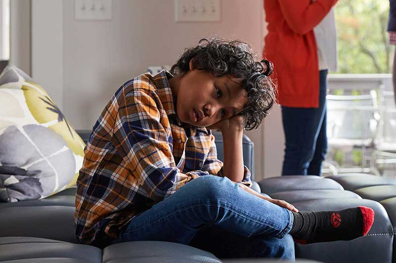 upset child with head in hands