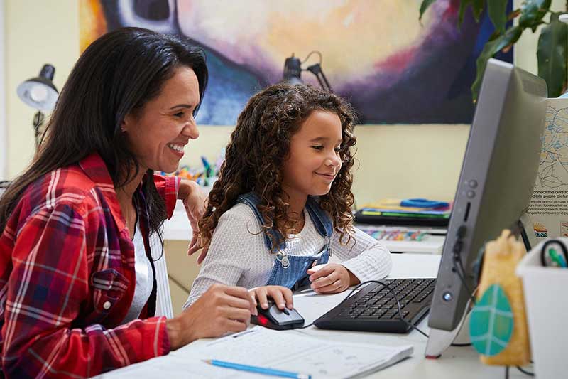 parent and child looking online together