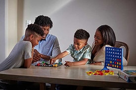 family playing board game together