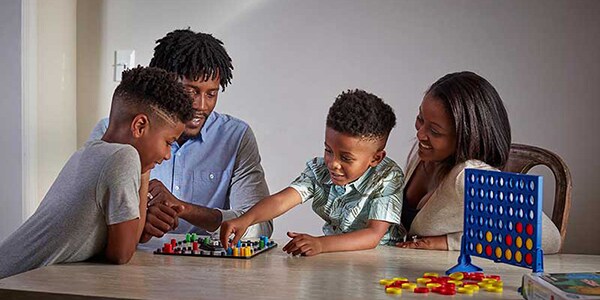 family playing board game together