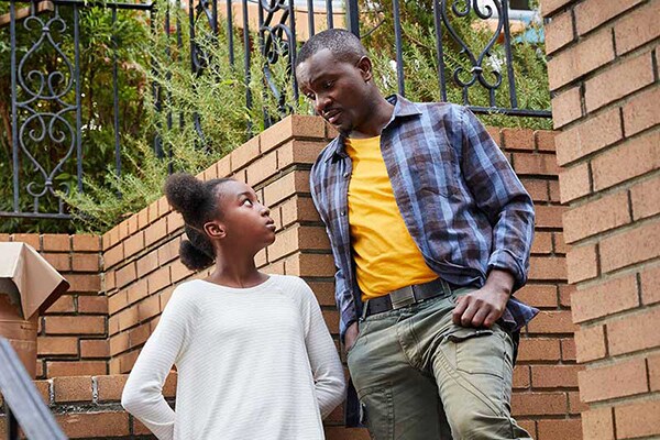 dad upset with teen daughter on brick steps