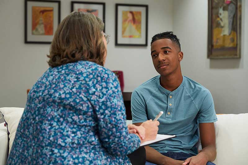 Teen sitting in therapy session