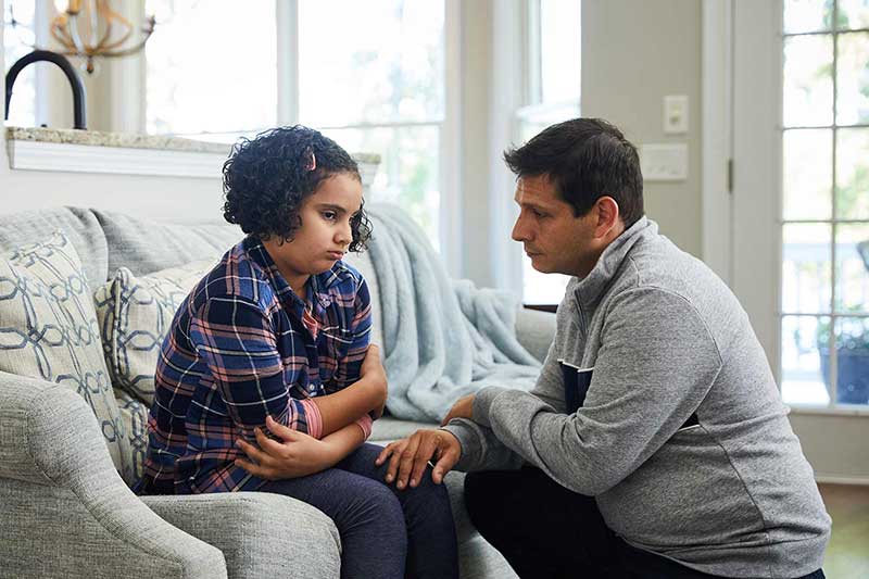 Father talking to upset daughter