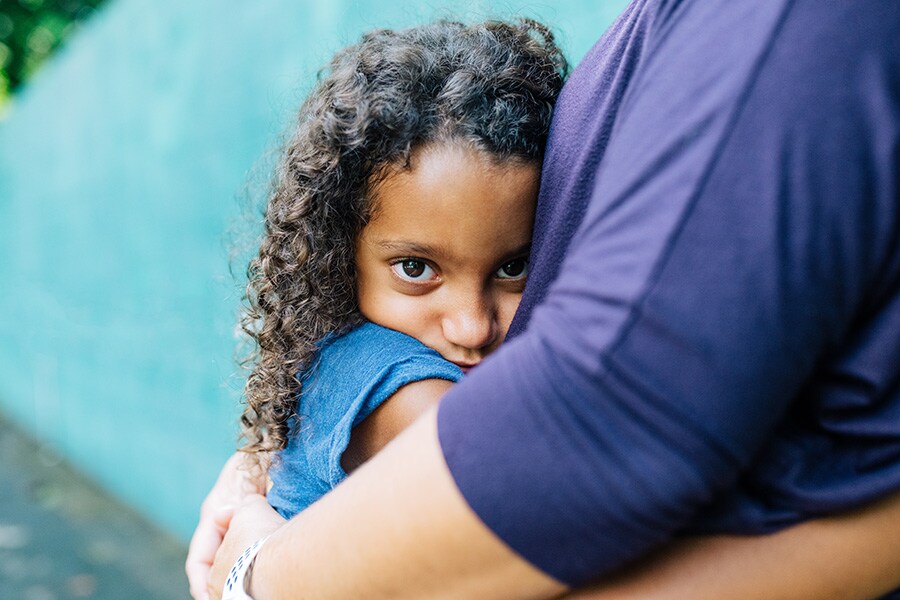 young girl hugging mom to foster emotional regulation skills and feel comforted while she’s upset