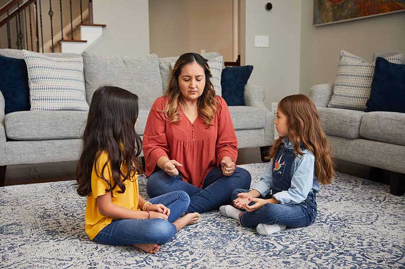 mom teaching daughters progressive muscle relaxation