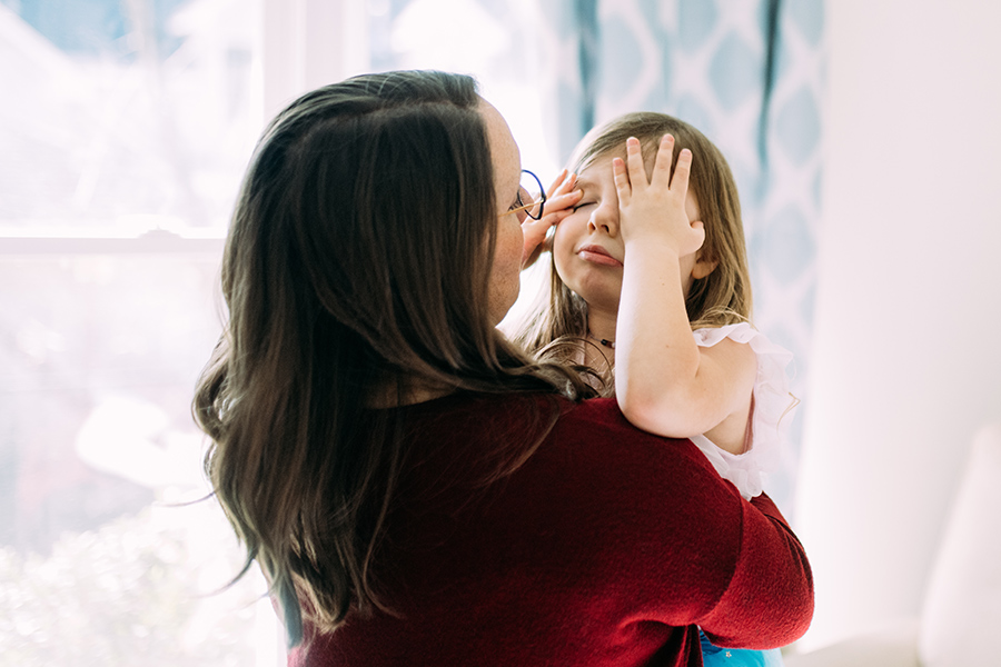 Mother holds and comforts crying daughter