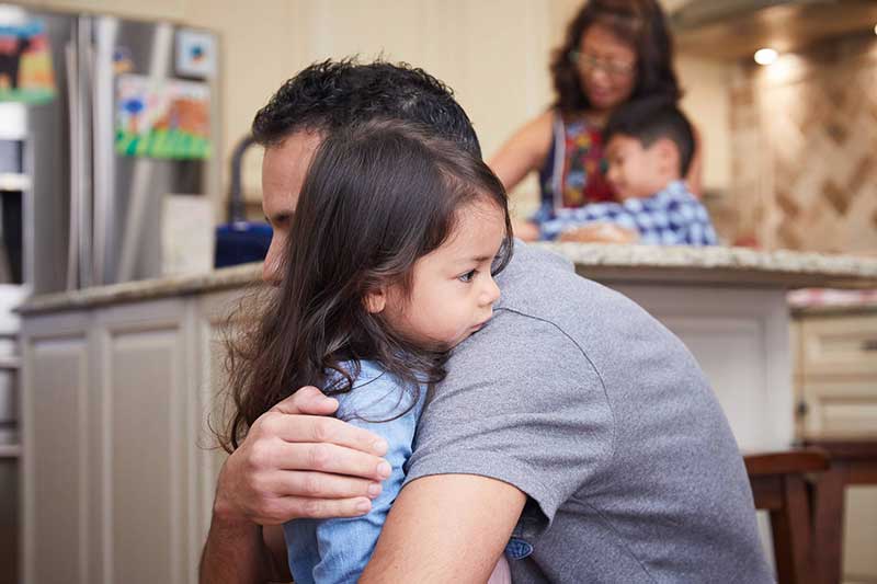 dad comforting upset daughter