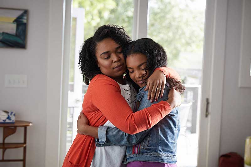 mom hugging daughter