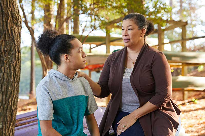 mom comforting upset teenager