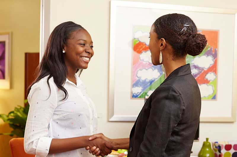 teen girl shaking hands with therapist