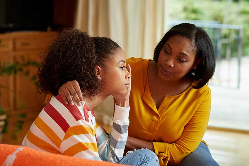 mom consoling daughter