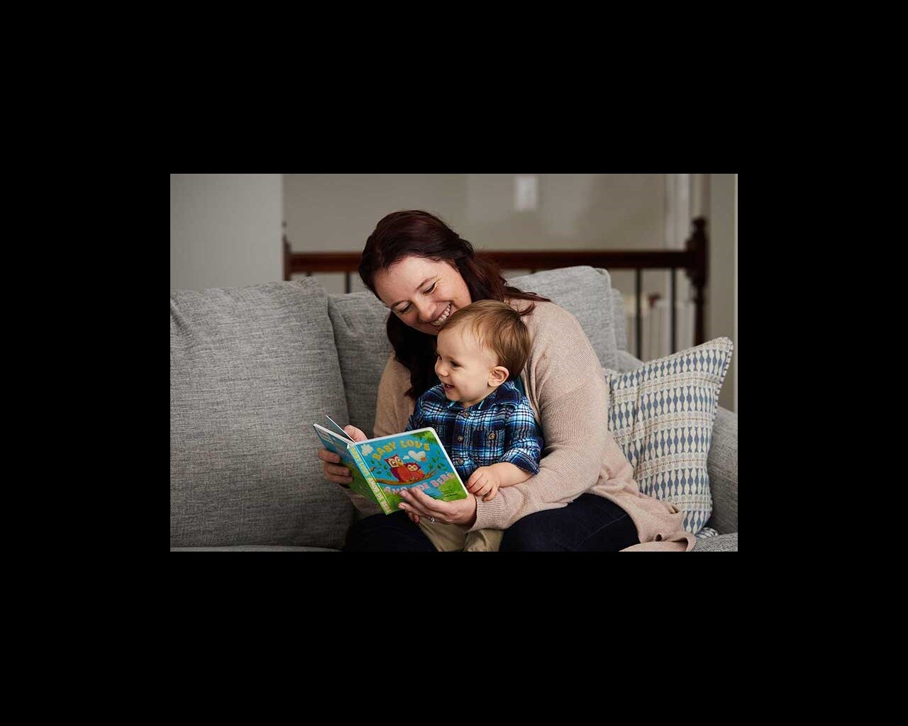Parent reading book to baby