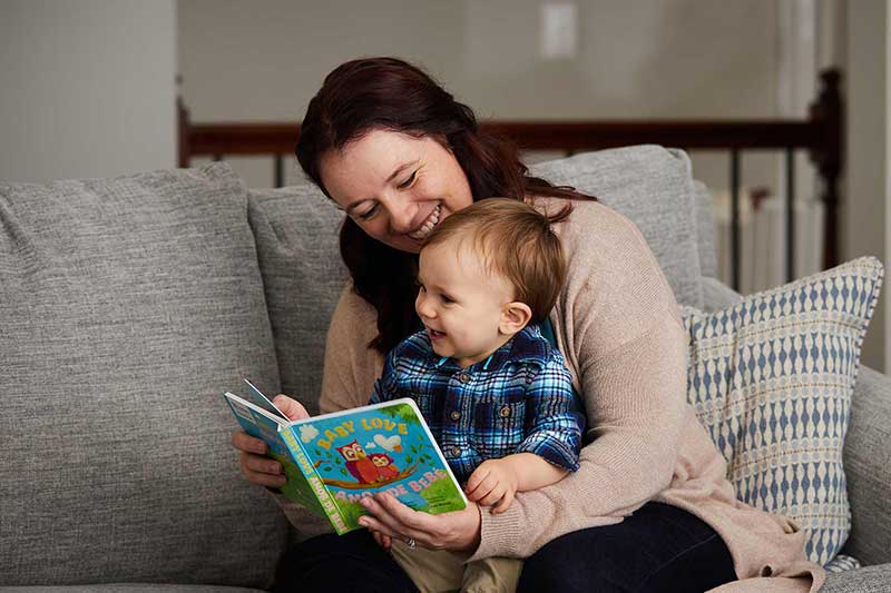 Parent reading book to baby