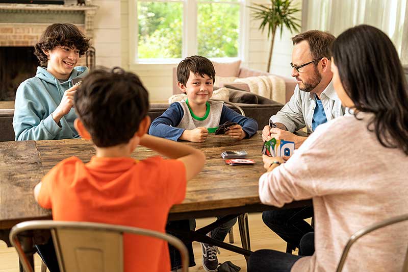 Family playing board game together