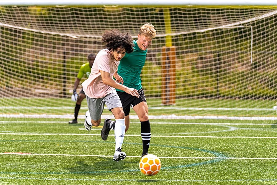 Teens playing soccer after school